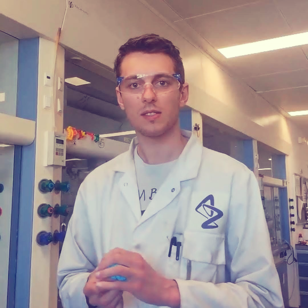 Albert standing in a lab in a white lab coat